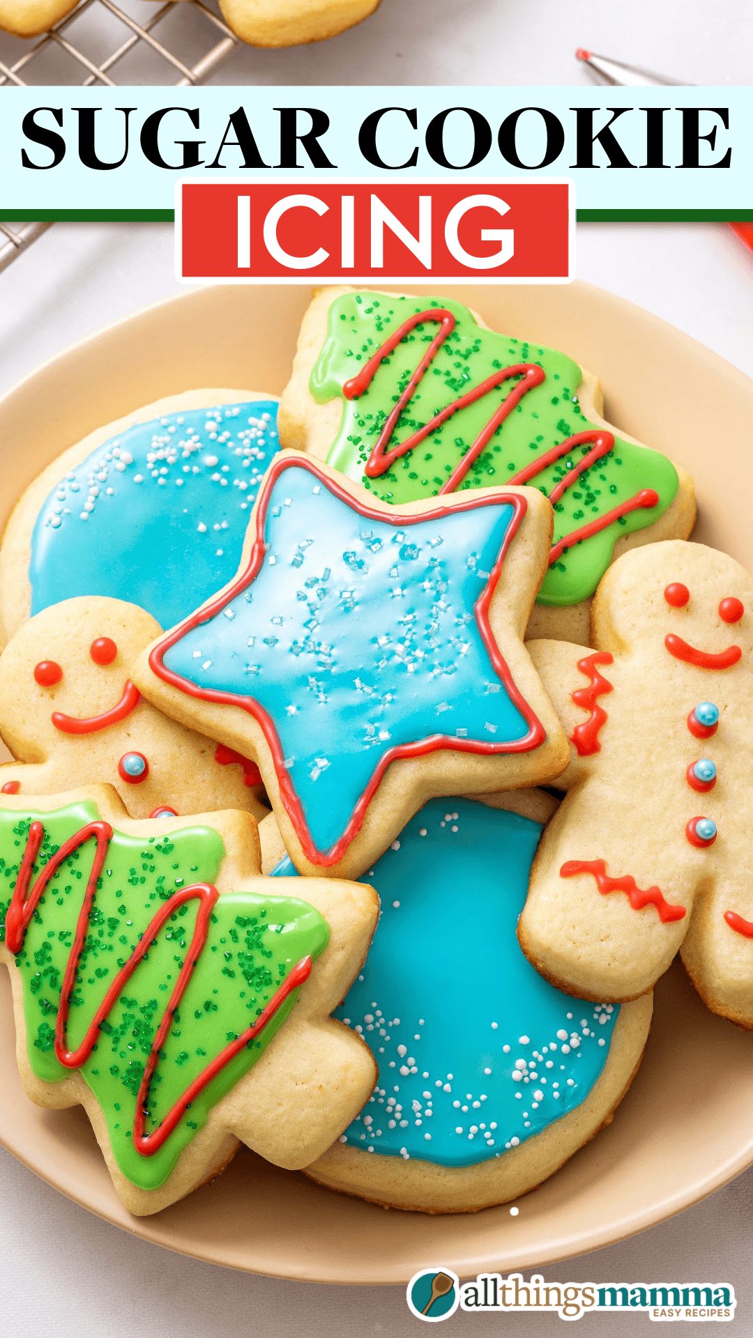A plate of festive sugar cookies decorated with colorful icing and sprinkles, including Christmas trees, stars, and gingerbread men.