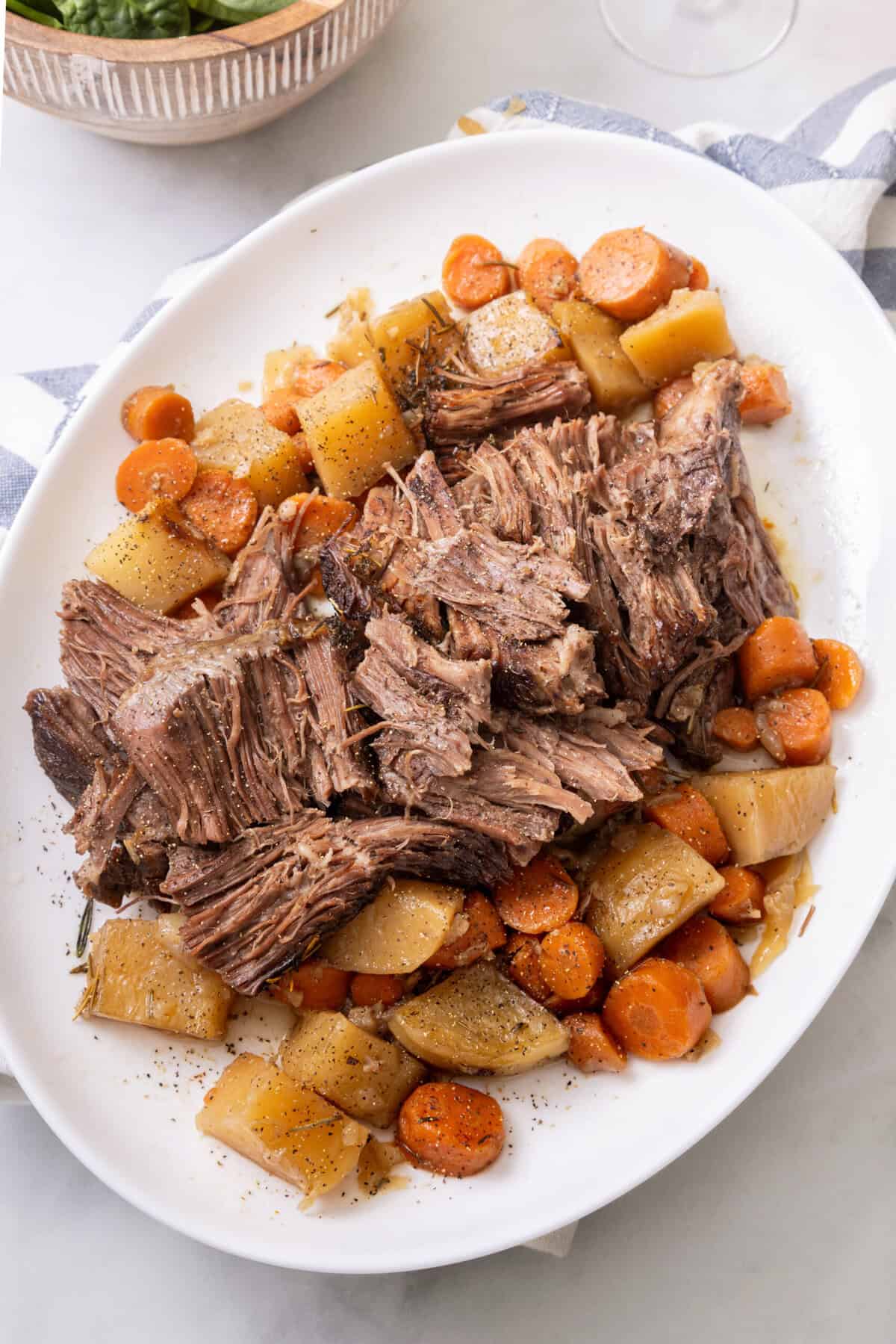 pot roast with carrots and potatoes on a plate.