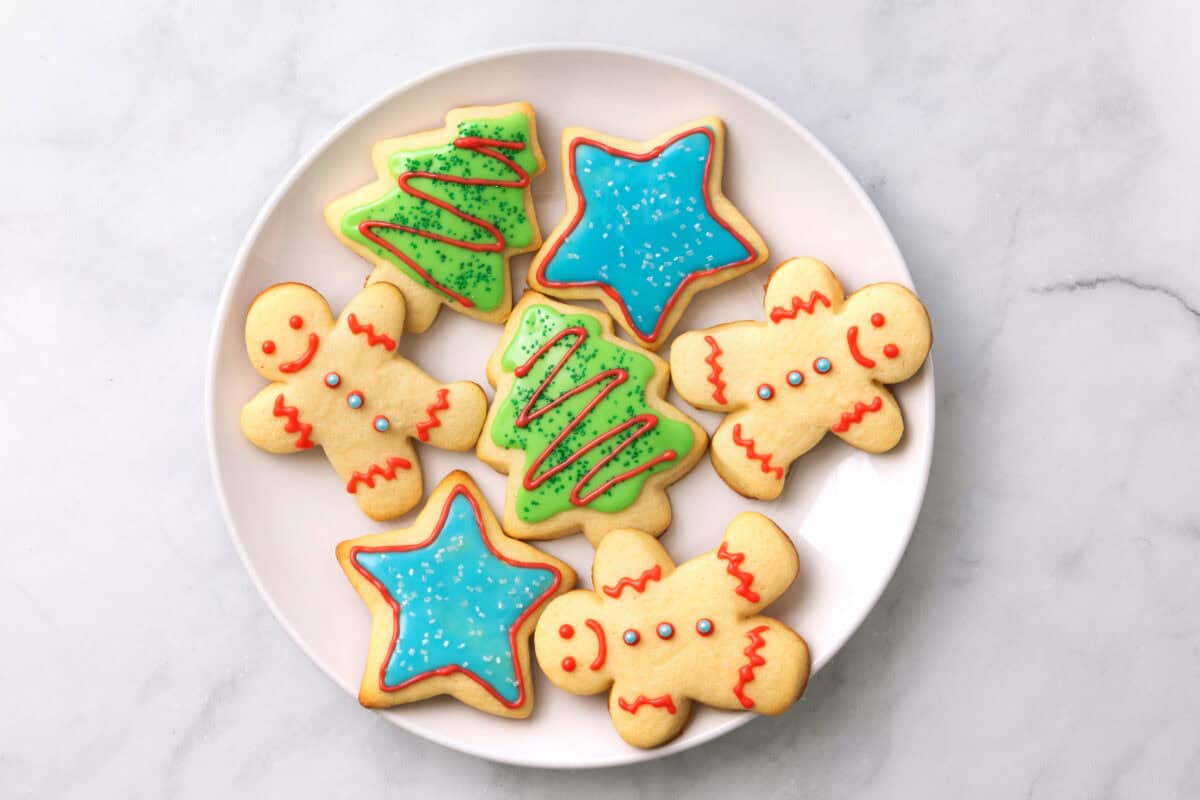 Sugar cookies decorated with icing on plate.