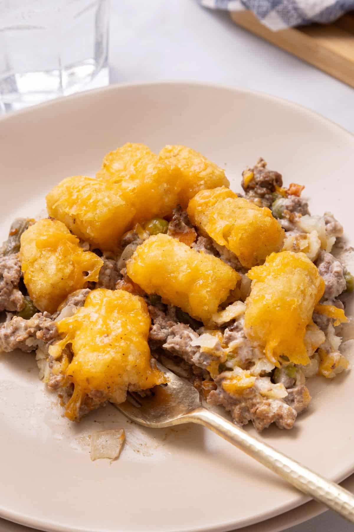 A serving of Tater Tot Casserole on a white plate. 