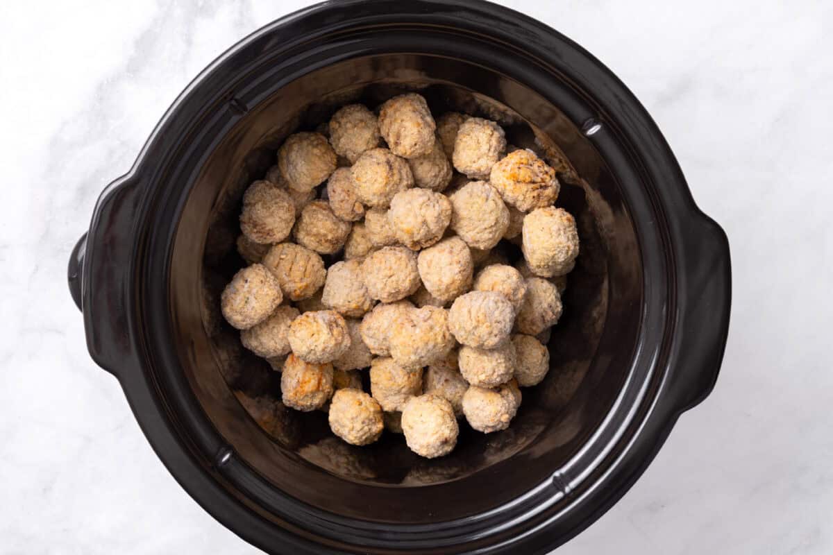 Frozen meatballs in a slow cooker.