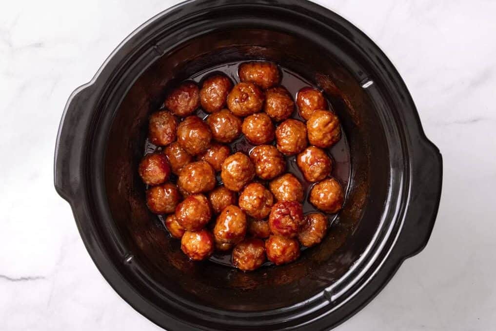 Cooked meatballs with sauce in the slow cooker. 