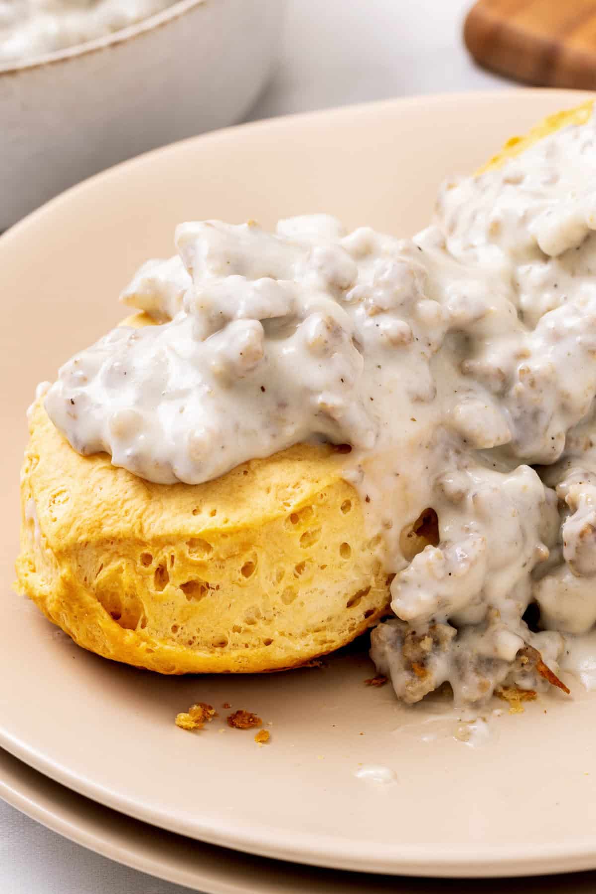 Sausage gravy and biscuits plate of biscuits with sausage gravy.