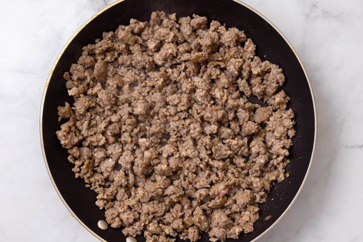 Cooked sausage in a skillet.