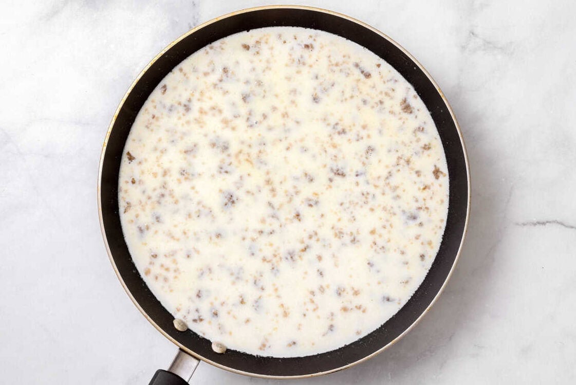 Sausage Gravy Cooked sausage gravy in a skillet.