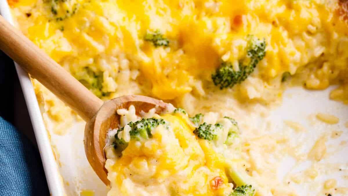 Cheesy broccoli rice casserole in a baking dish with servings missing.