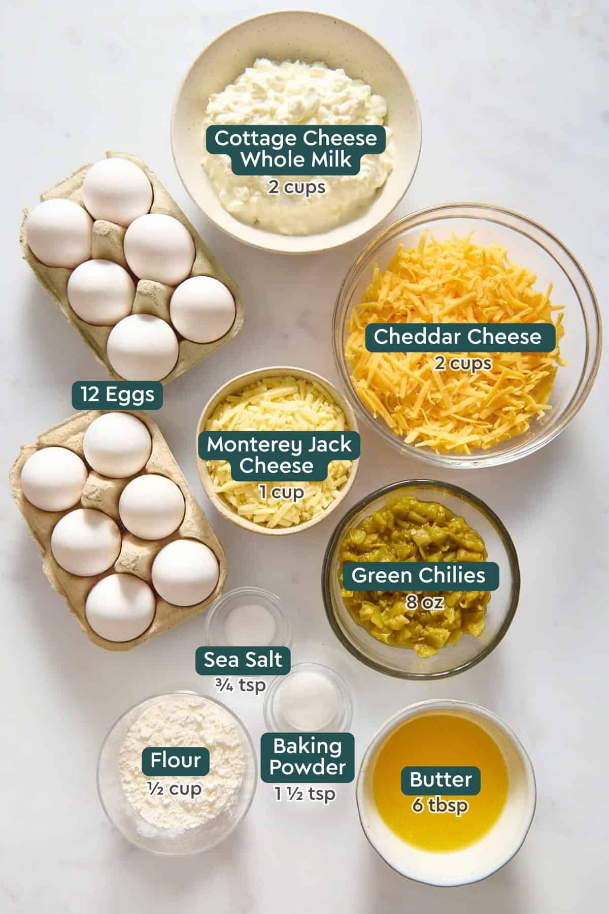 Ingredients for green chile egg casserole, including cottage cheese, eggs, cheese, green chlies, salt, flour, baking powder, and butter.