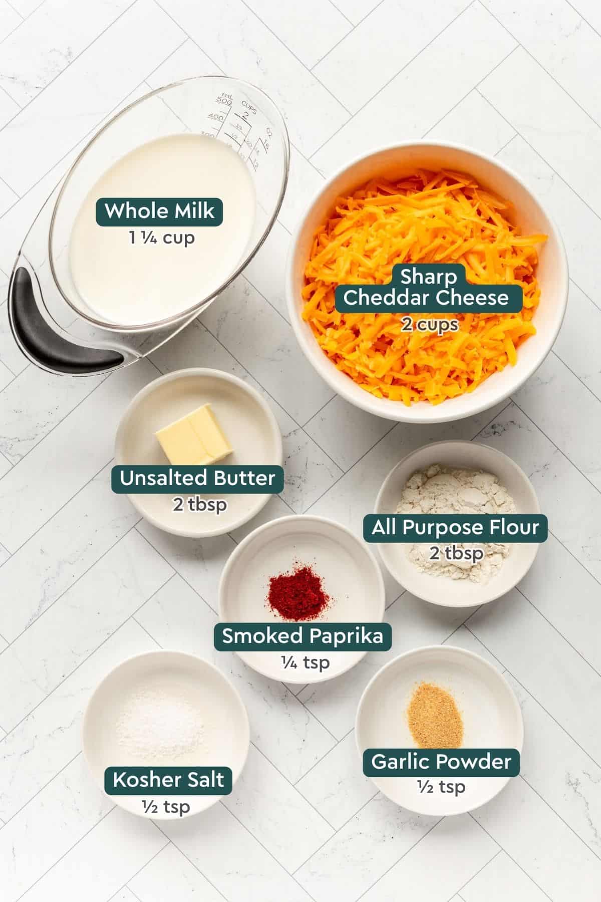 Ingredients for pretzel cheese dip, including milk, cheese, butter, flour, paprika, salt, garlic powder.