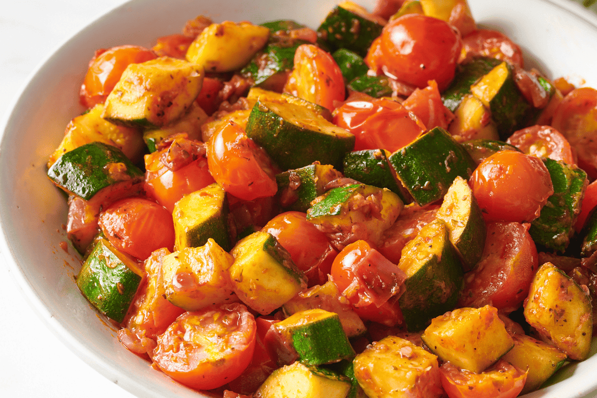 A bowl of sautéed zucchini and tomatoes.