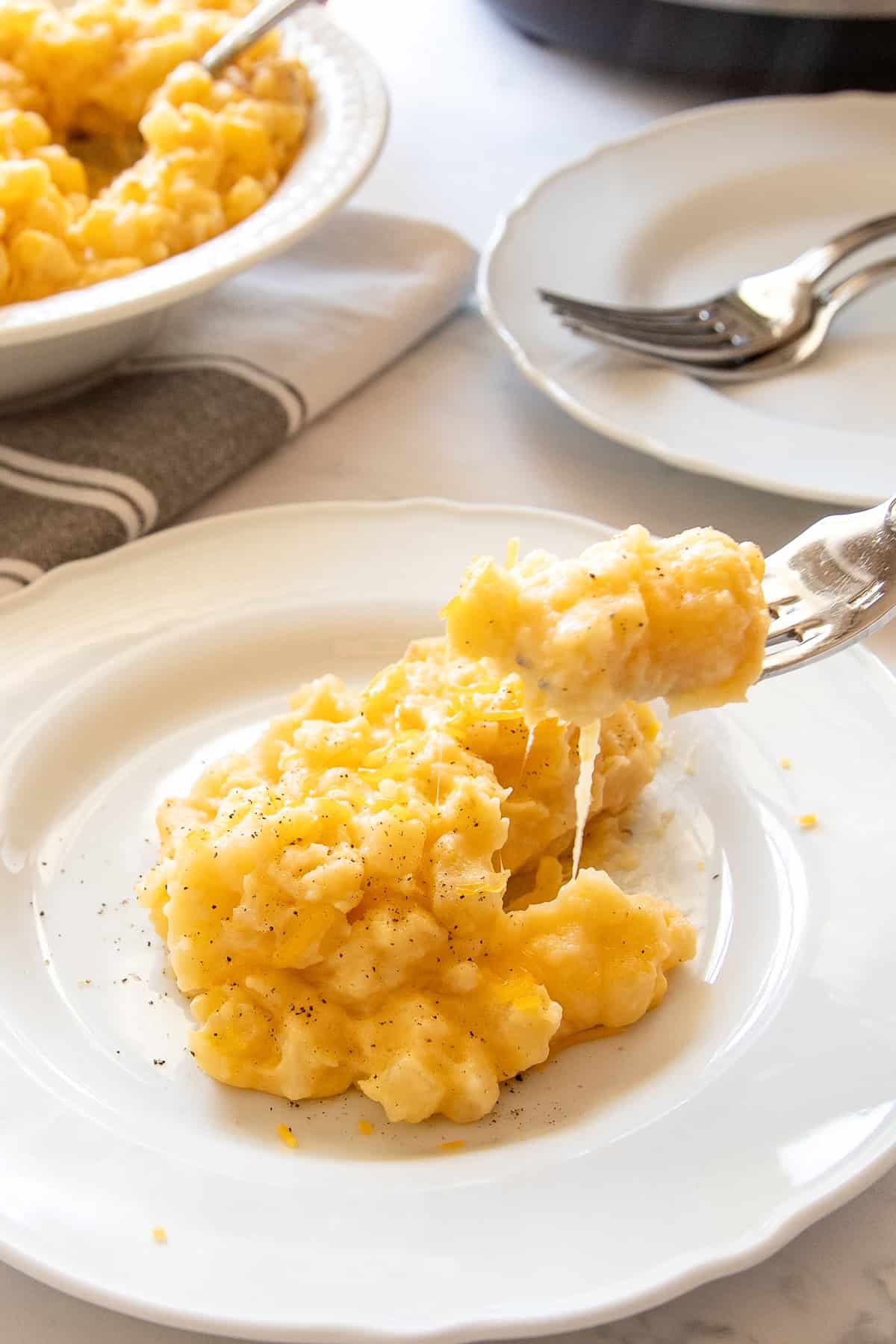 forkful of cheesy potatoes made in a crockpot