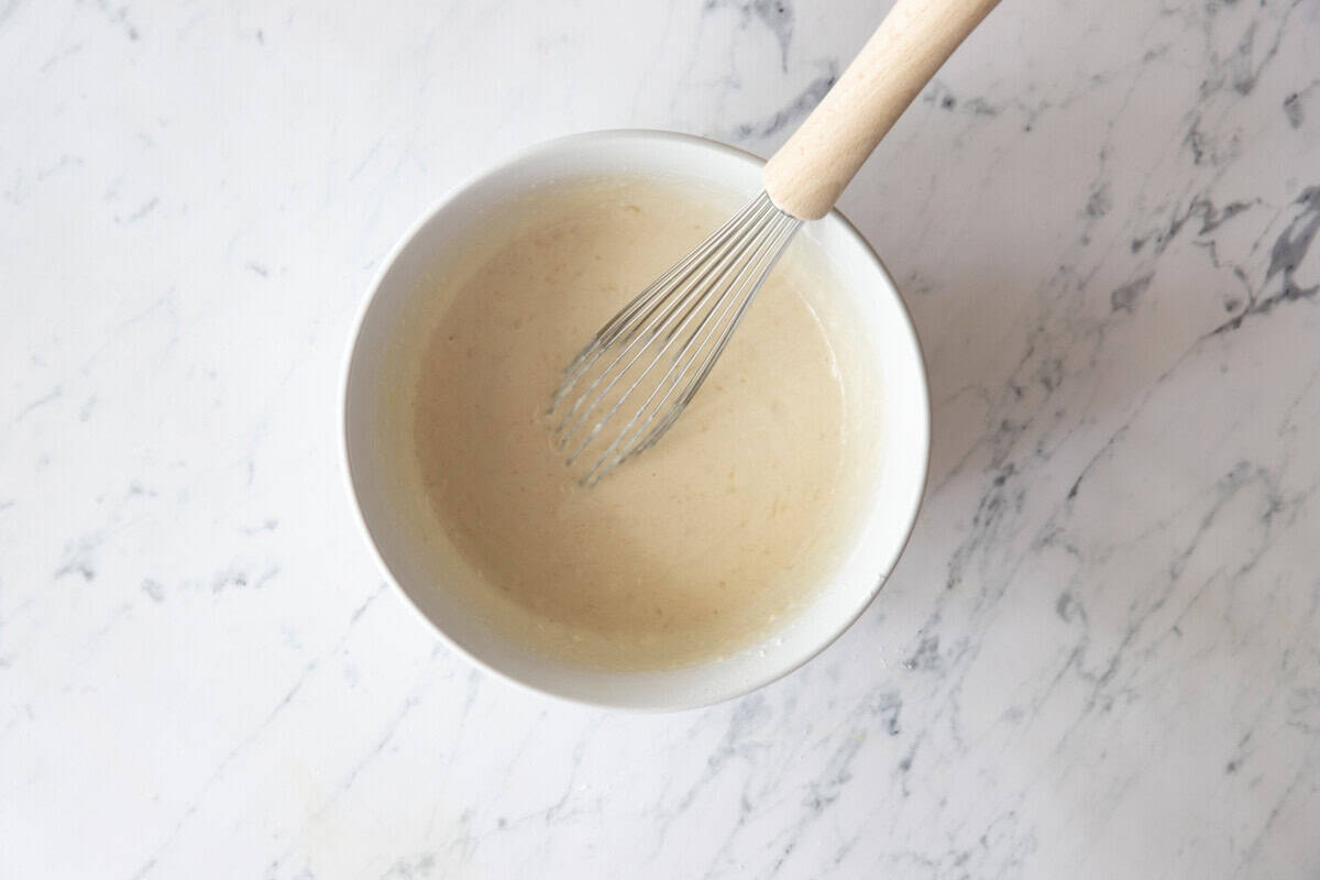 Whisking pancake batter in bowl.