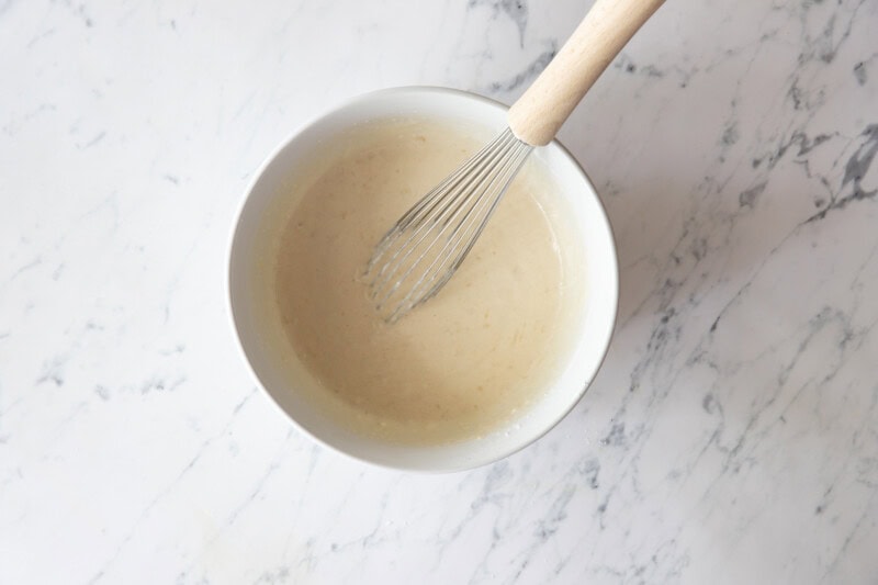 Whisking pancake batter in bowl