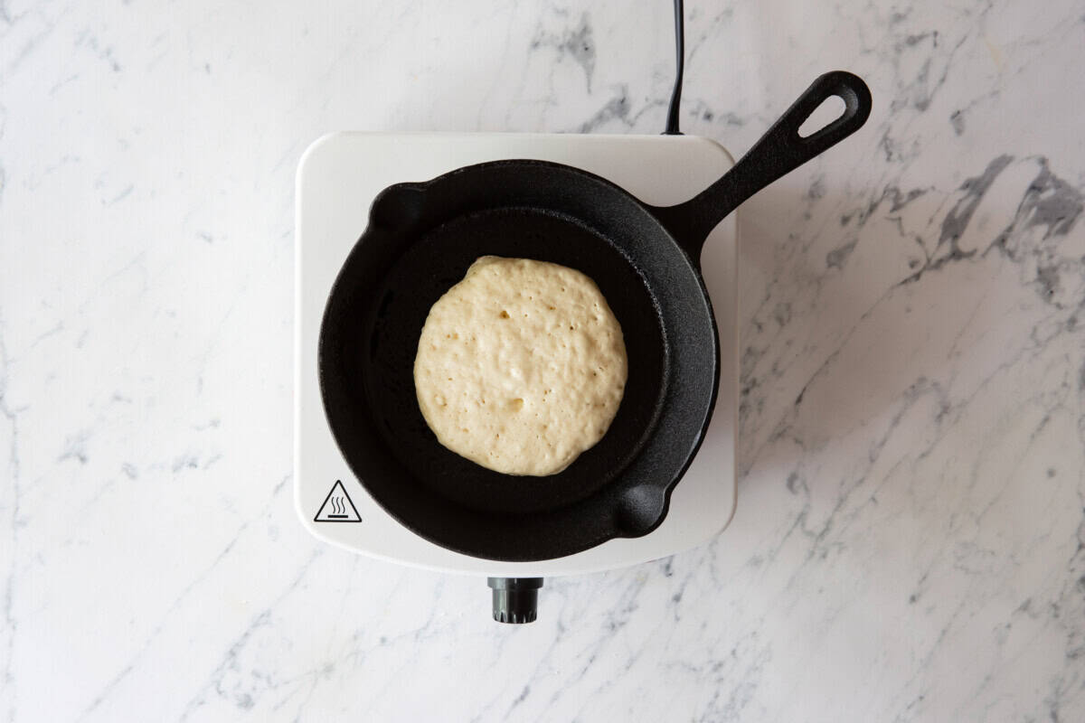 Pancake cooking in skillet.