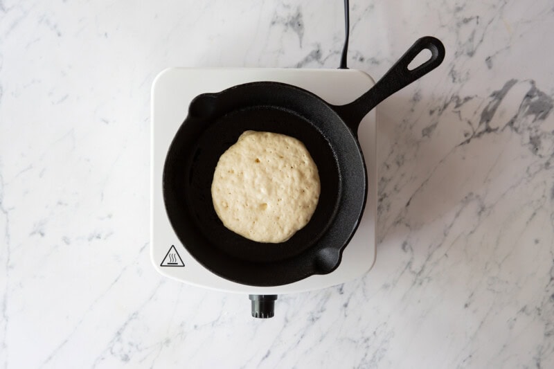 Overhead view of pancake cooking in skillet