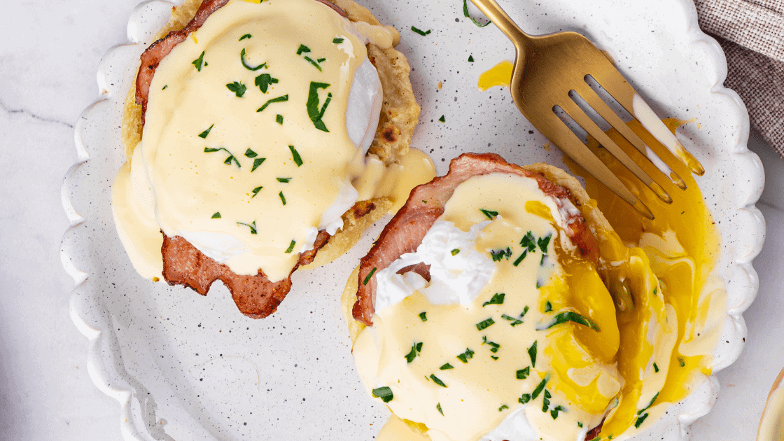 top view of eggs benefit with ham and homemade hollandaise sauce served on a plate