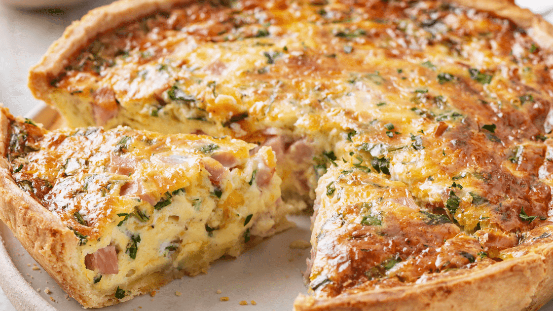 slice cut from ham and cheese quiche