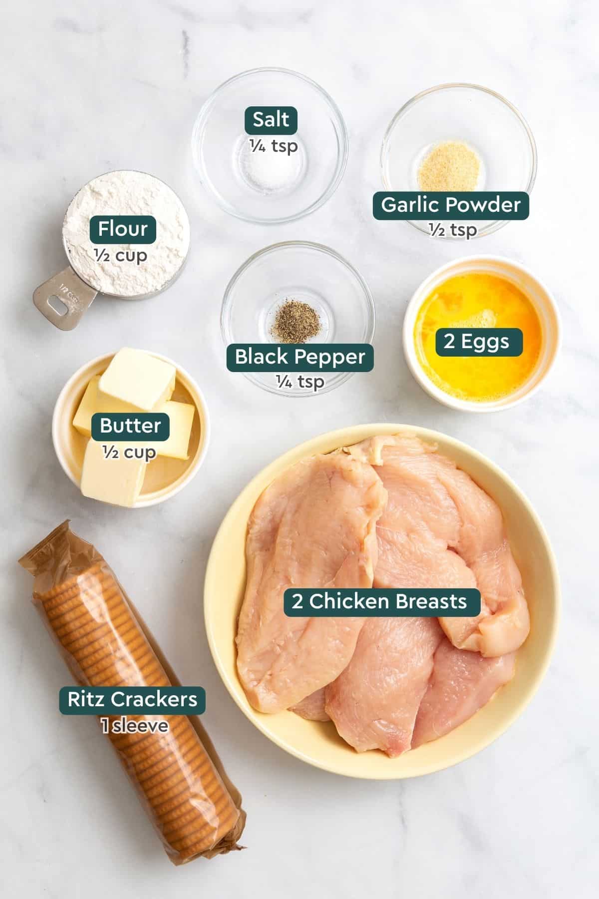 Ingredients for Ritz crackers chicken, including salt, garlic powder, pepper, flour, eggs, butter, chicken, and Ritz crackers.
