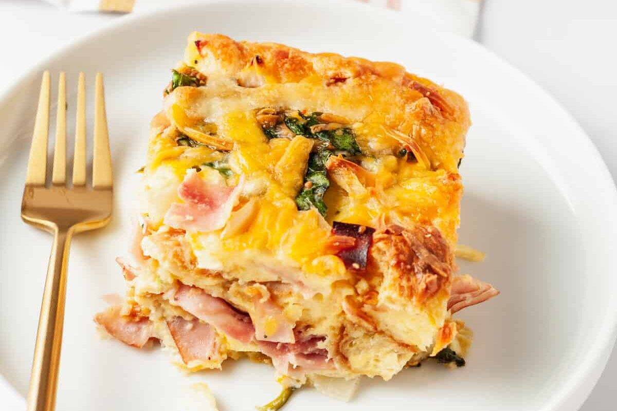 A serving of breakfast croissant casserole on a plate.