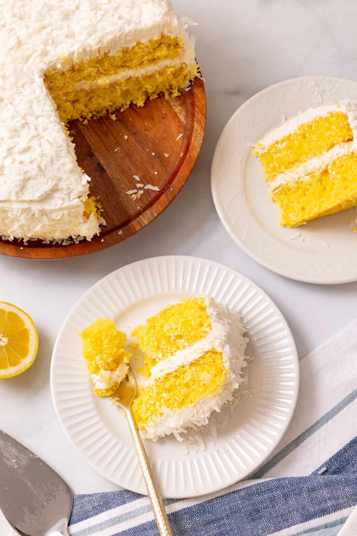 Lemon coconut cake slice on a white plate.