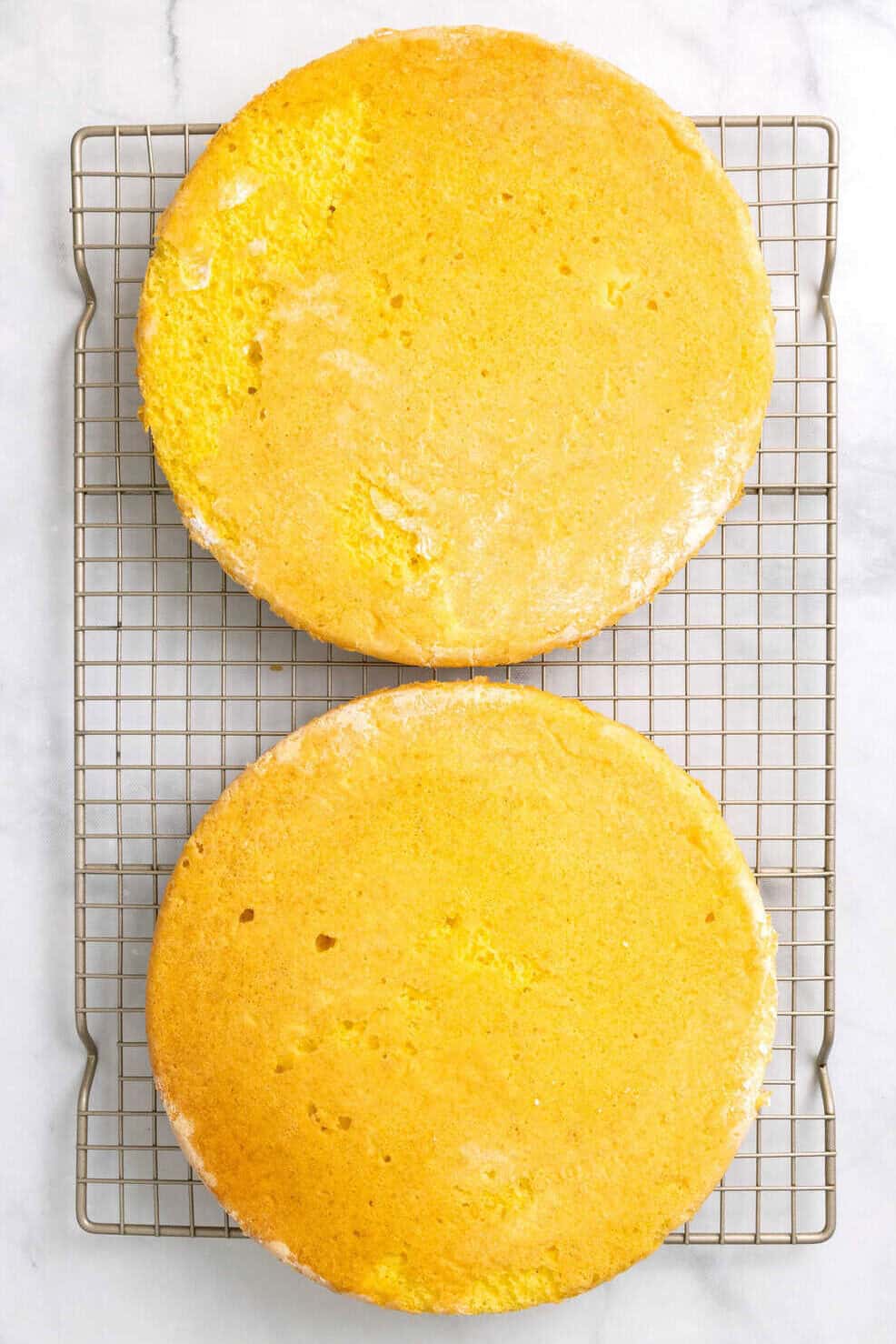 baked lemon coconut cakes on a cooling rack.
