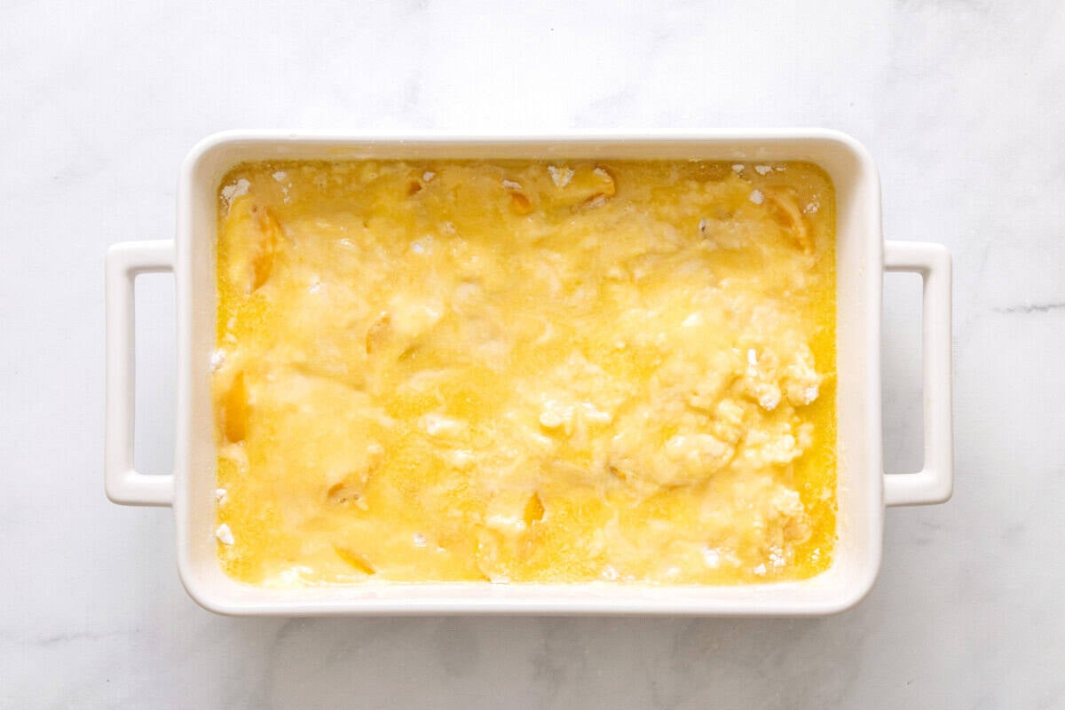 Unbaked peach cobbler with cake mix.