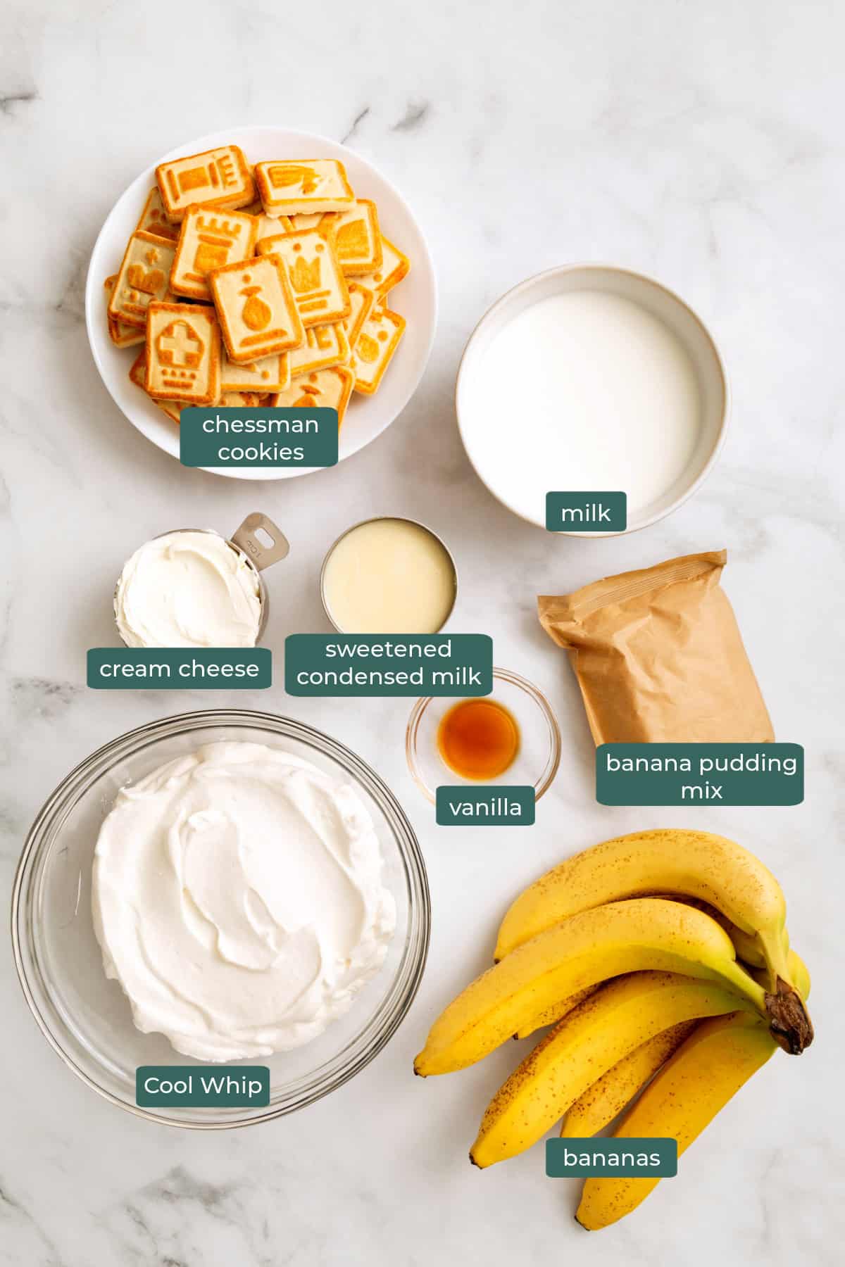 All of the ingredients for chessman banana pudding in bowls on a countertop.