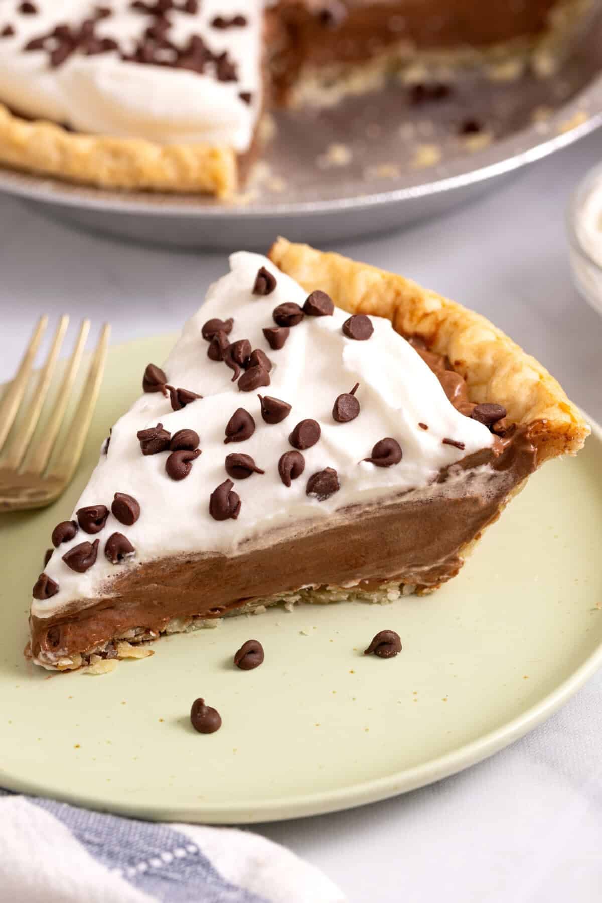 Slice of chocolate cream pie on plate.