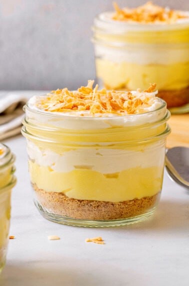 Coconut cream pie parfait in mason jar with toasted coconut on top