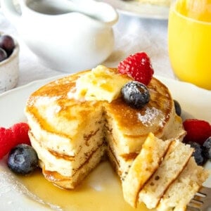 pancakes on a plate with a bite on a fork