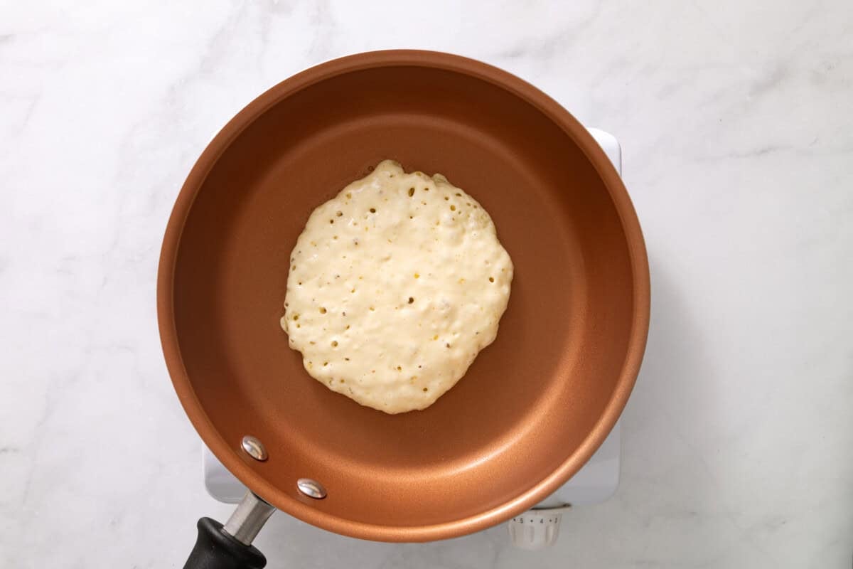 Pancake batter added to pan.