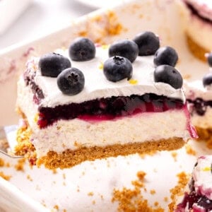 Slice of lemon blueberry delight being lifted from baking dish