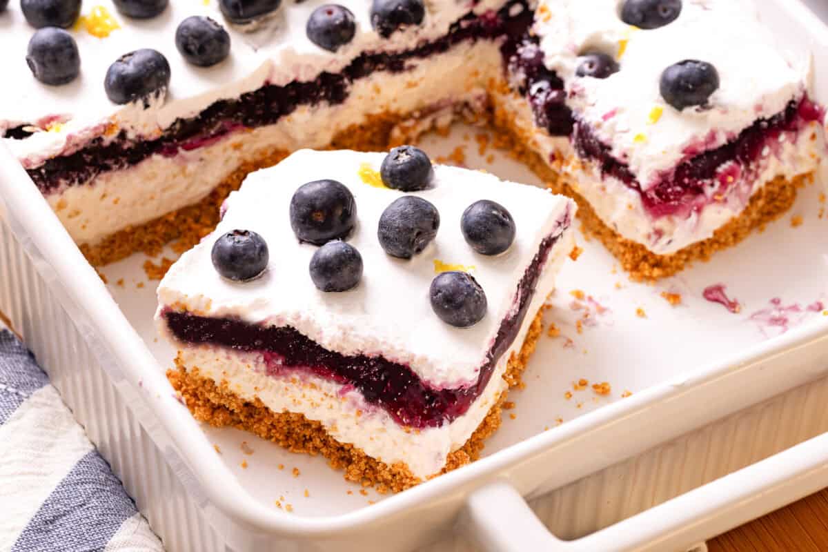 Slice of lemon blueberry delight in baking dish
