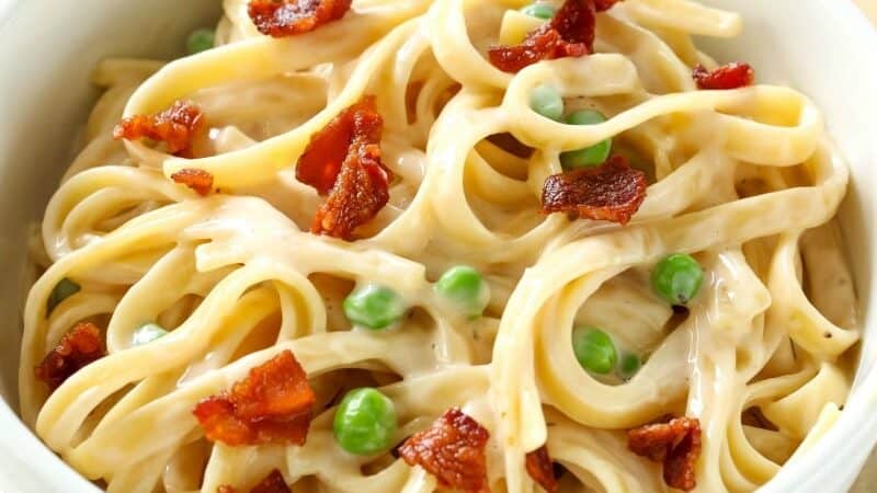 For a quick and easy dinner idea that tastes gourmet, try this Fettuccine Carbonara recipe! It's rich, creamy and ready in 30 minutes!  Your entire family will love it! #fettucinicarbonara #easyfettucinicarbonara #pasta #easydinner #bacon #allthingsmamma | allthingsmamma.com