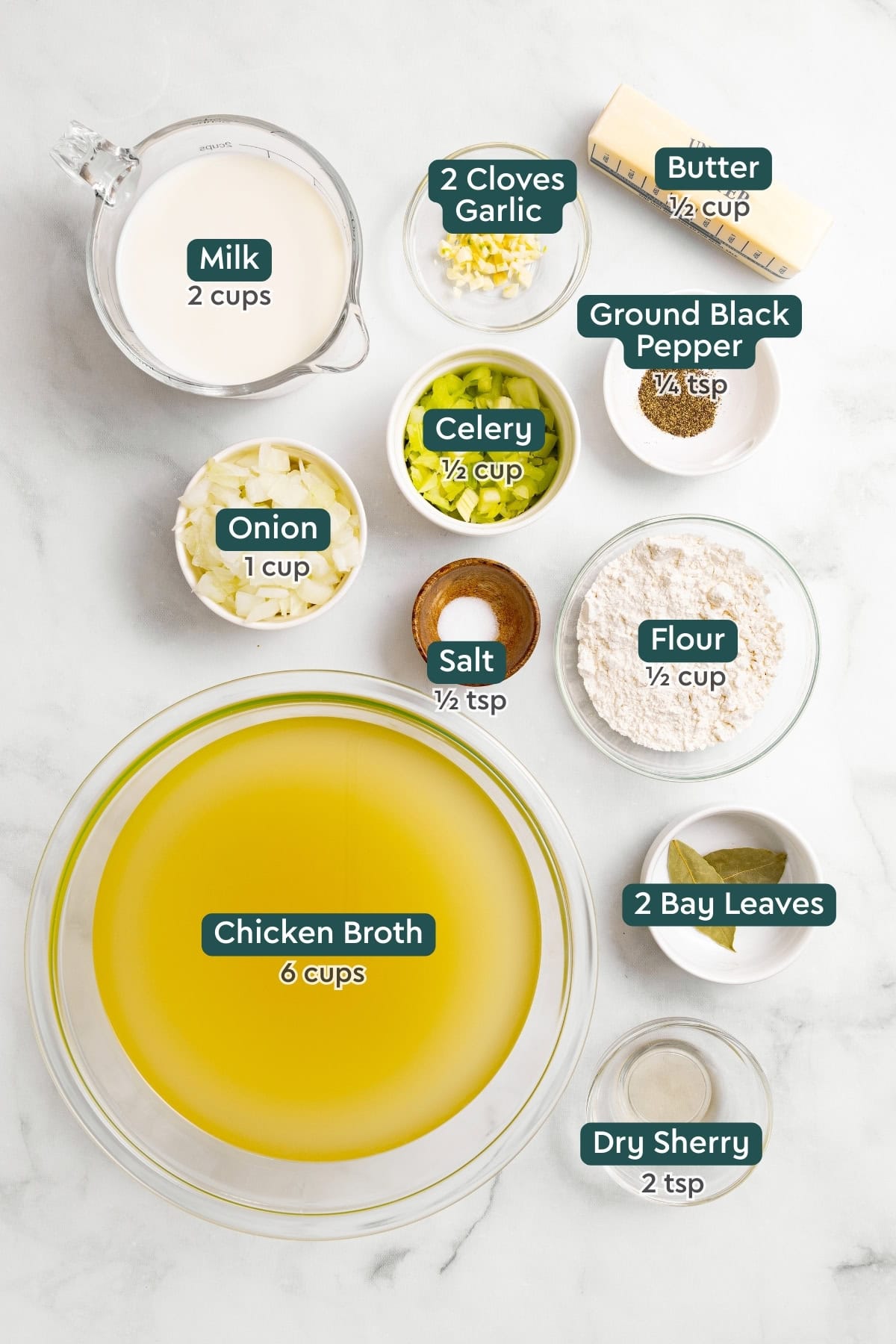 All of the ingredients for homemade cream of chicken soup in bowls on a white countertop.