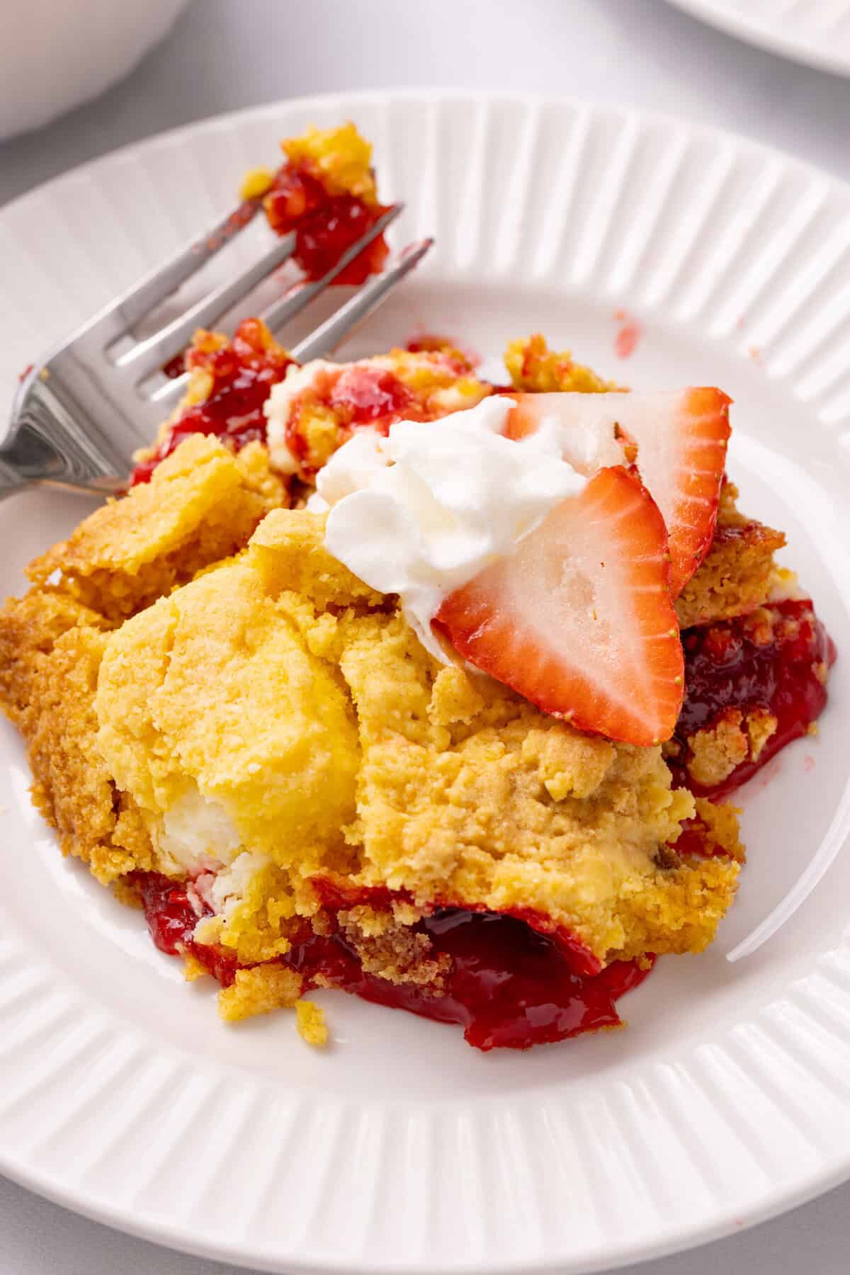 strawberry cheesecake dump cake with whipped cream. 