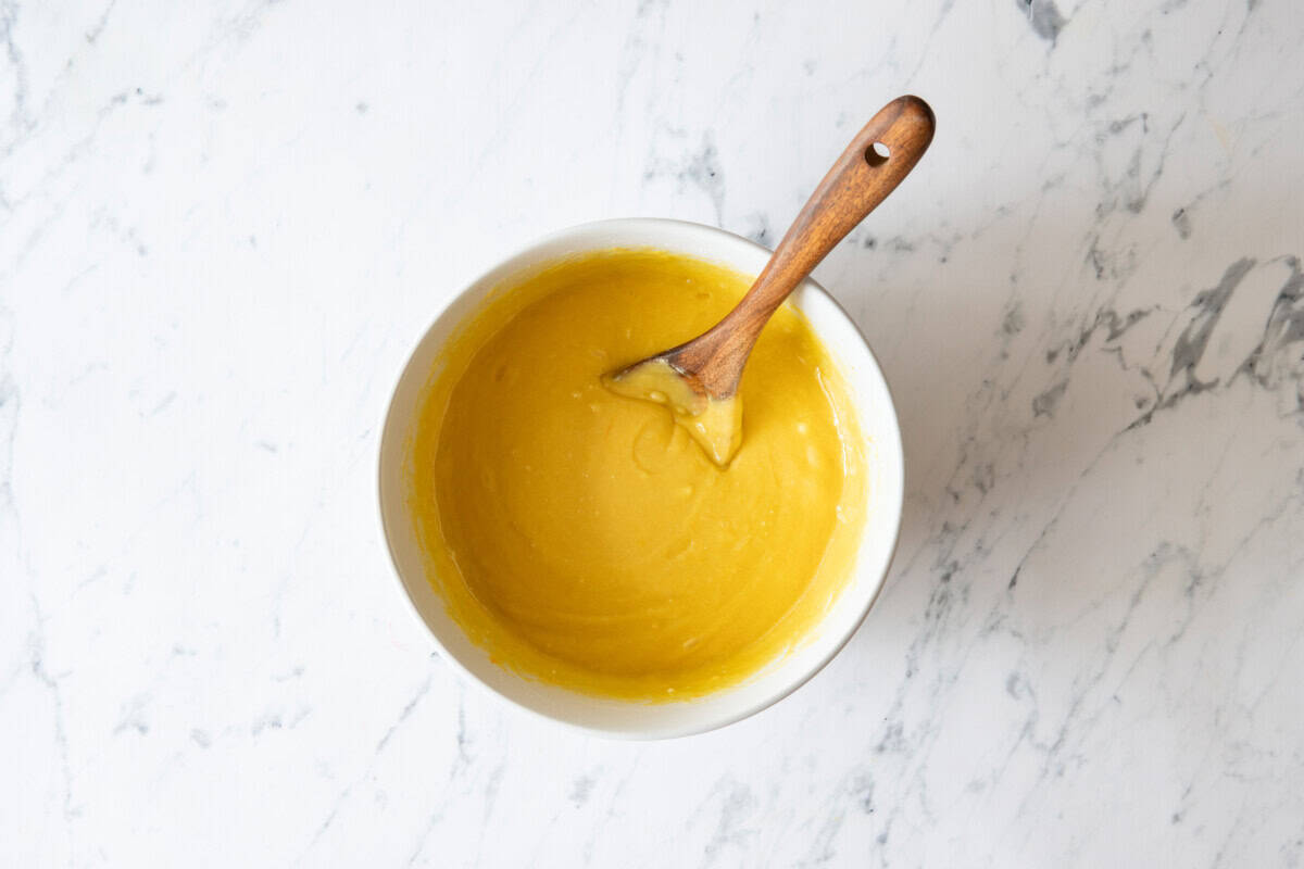 7up cake batter in bowl with wooden spoon.