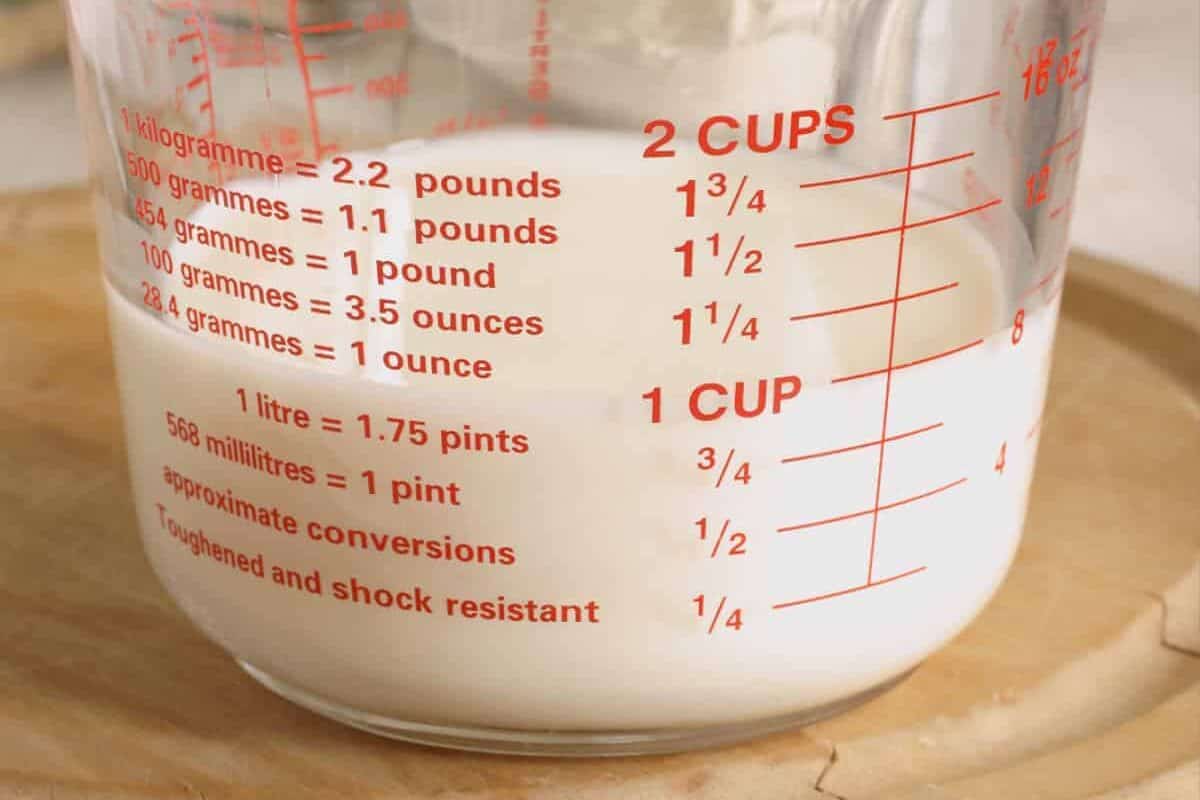 glass measuring cup with buttermilk.