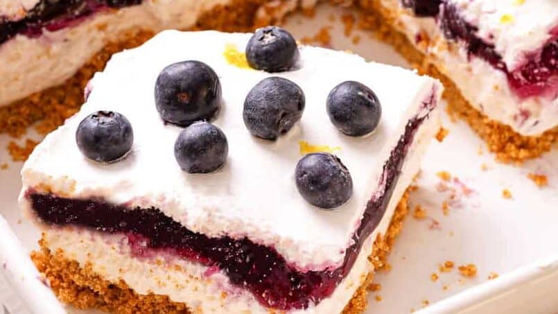 Slice of lemon blueberry delight in baking dish