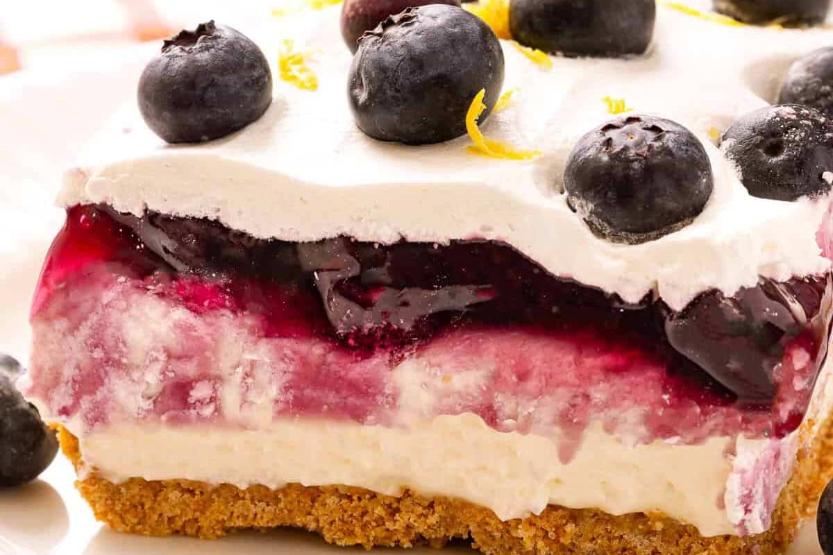 Slice of lemon blueberry delight on plate