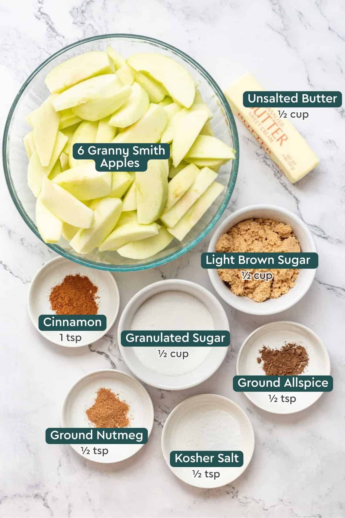 All of the ingredients for fried apples in bowls on a white countertop.