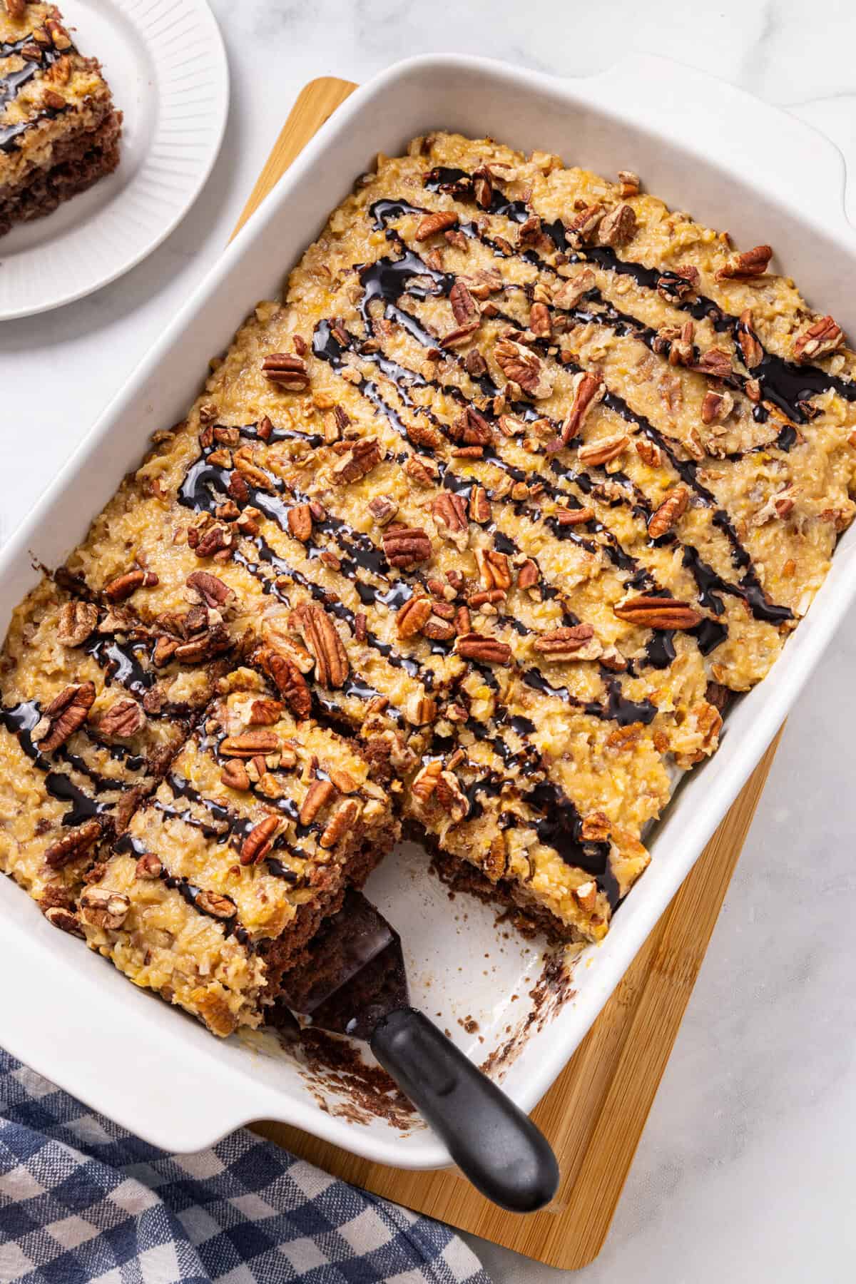 German Chocolate cake in the cake pan with one slice missing.