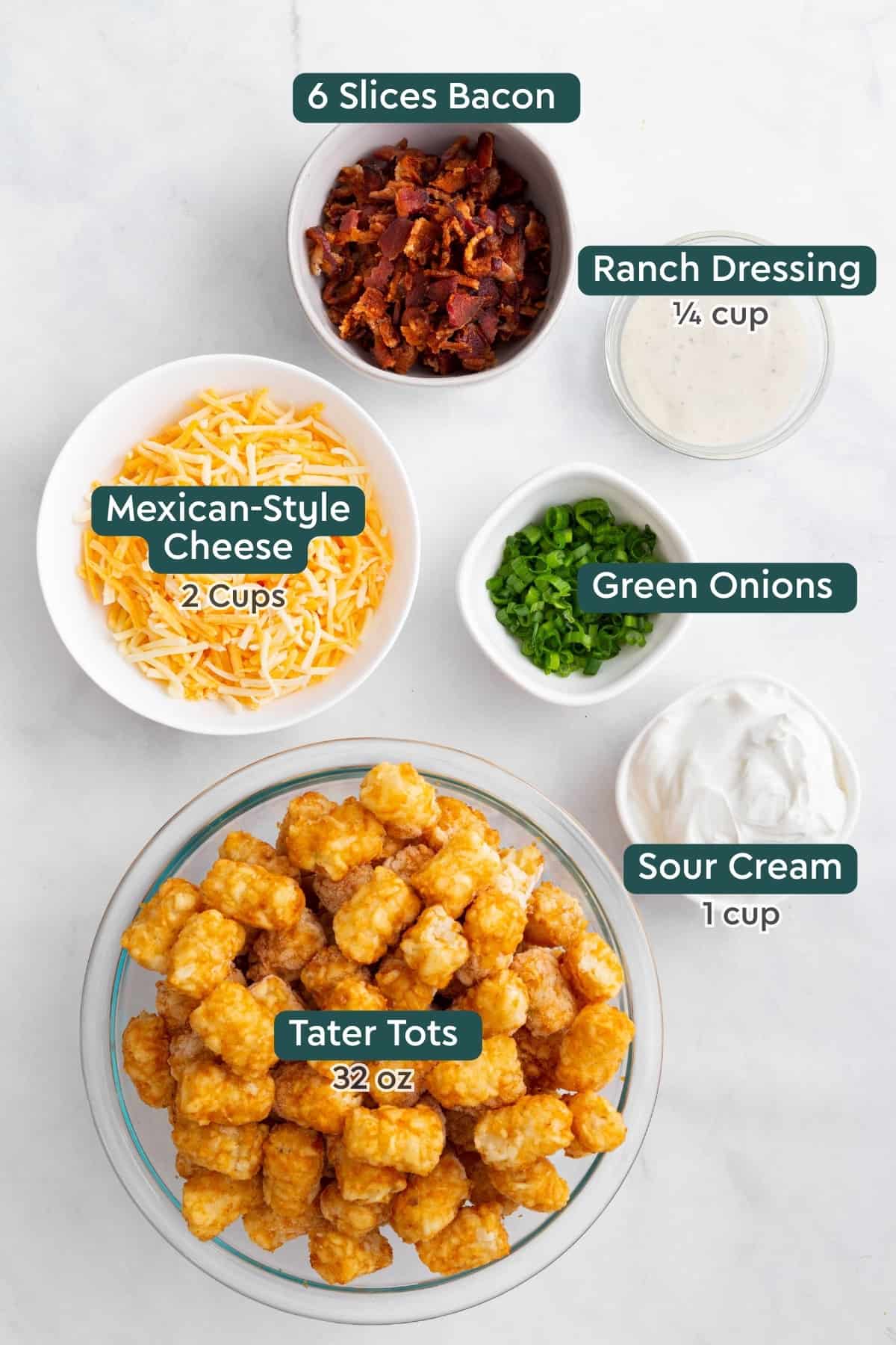 Loaded Tater Tots ingredients shot, featuring: bacon, ranch dressing, Mexican-style cheese, green onions, sour cream, and frozen tater tots.