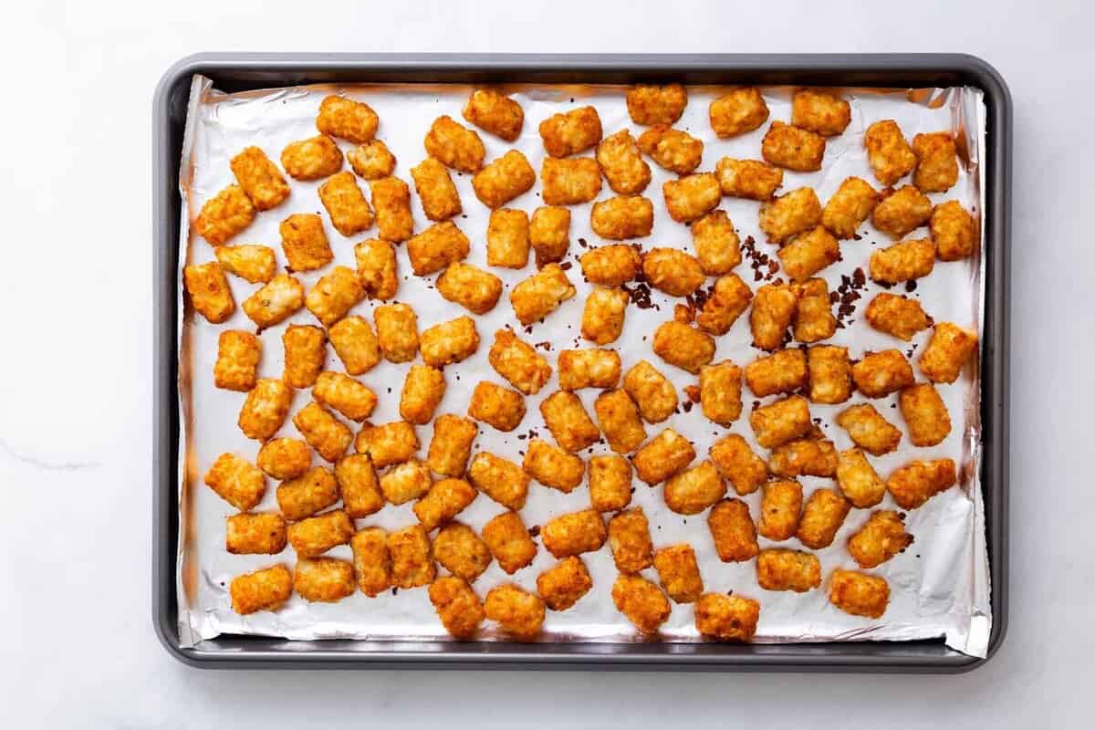 Step 1 to make loaded tater tots: bake the tater tots in the oven.