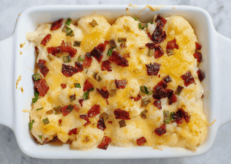 Baked cheesy cauliflower casserole in dish.