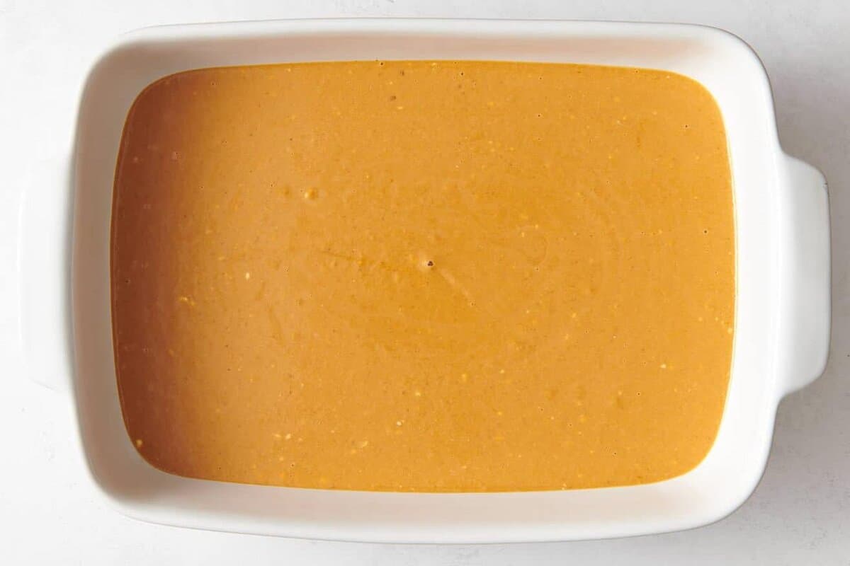 Pumpkin filling for cobbler in baking dish.