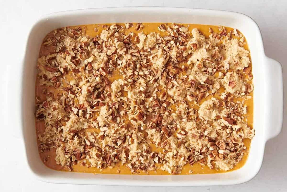 Pecan topping for pumpkin cobbler in baking dish.