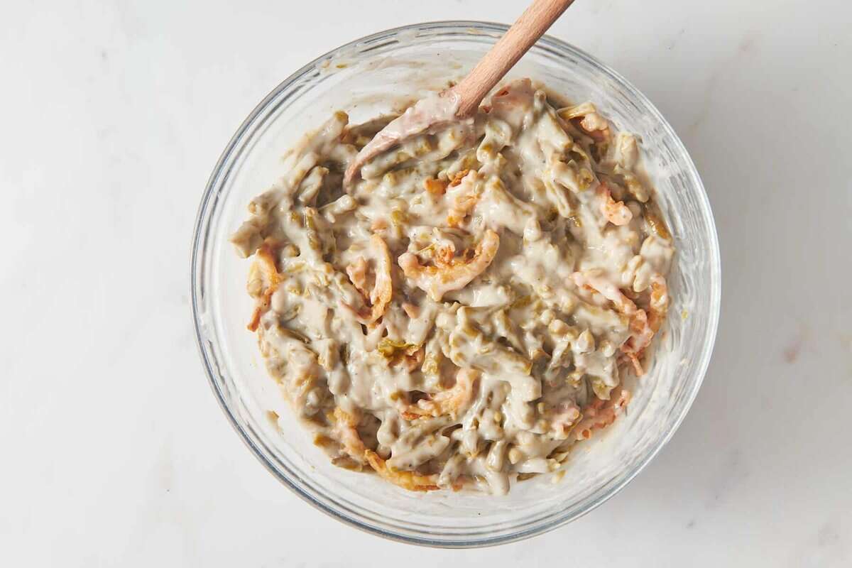 Stirring beans and fried onions into mushroom sauce.