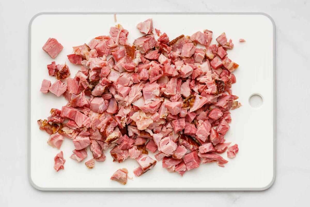 Cut bacon on a white cutting board. 