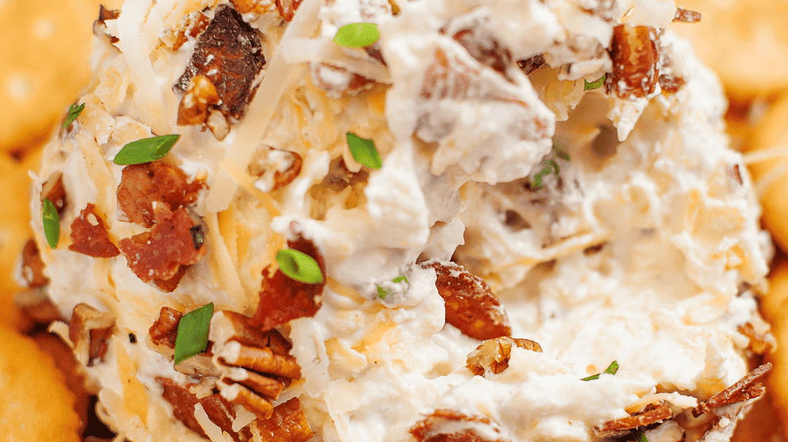 cheese ball recipe sitting on top of a bed of rtiz crackers