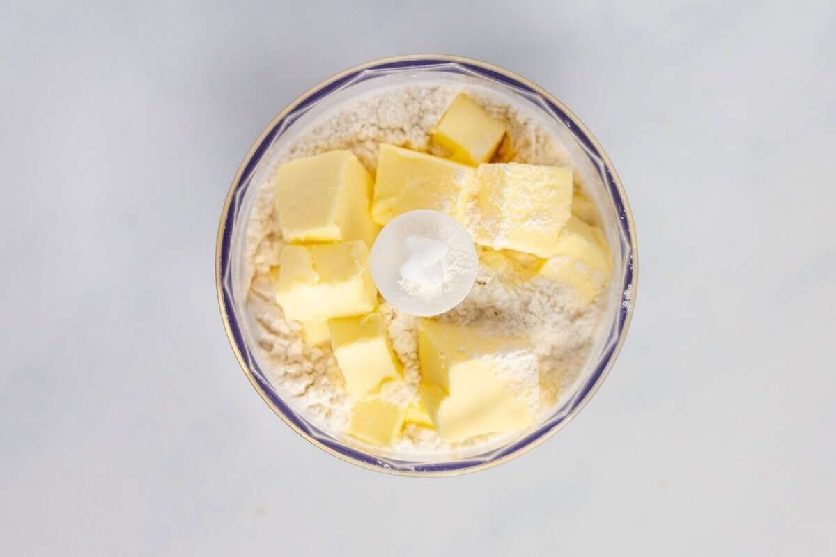 Butter in food processor with flour and dry ingredients.